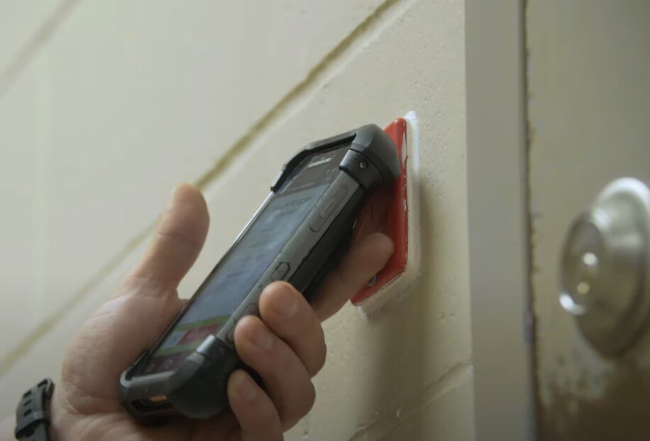 Close up of device scanning hard tag 