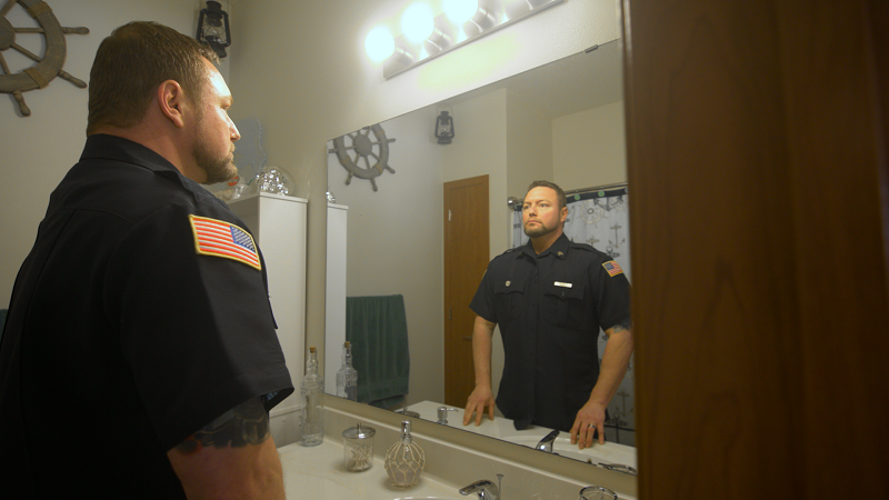 corrections officer looking in mirror