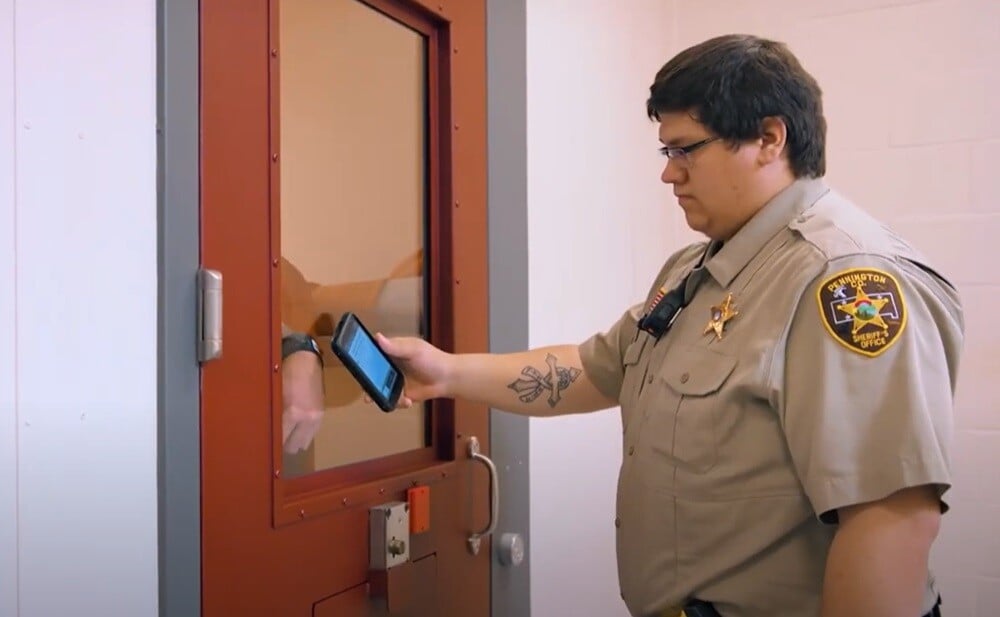 correctional-officer-scanning-inmate-identification-wristband