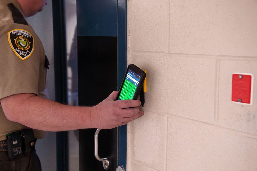 corrections officer scanning rfid hard tag