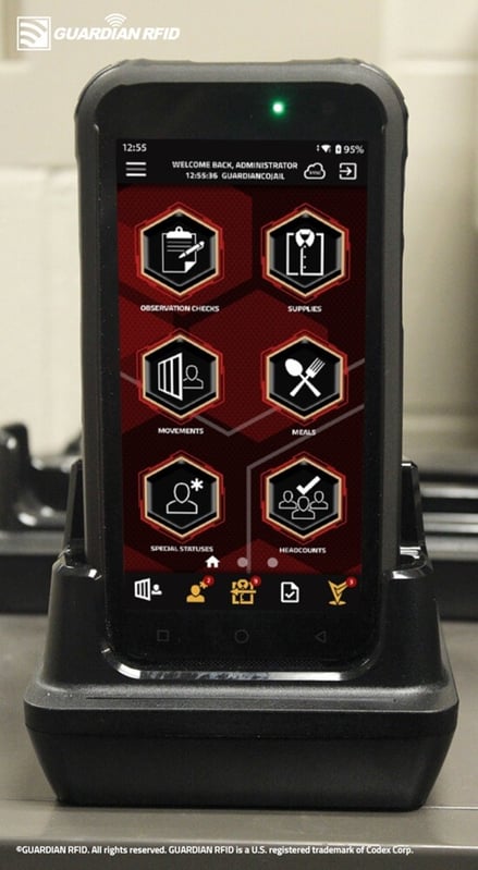 inmate tracking mobile device in cradle