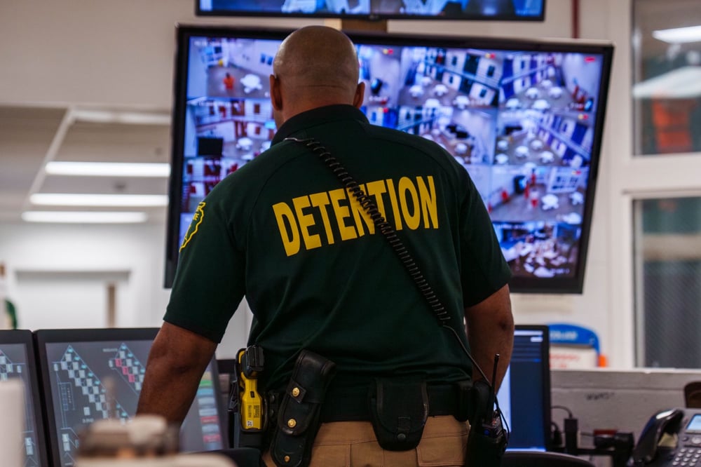corrections officer watching cameras