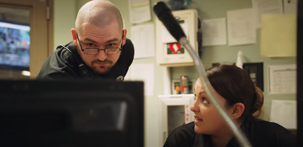 two corrections officer on computer