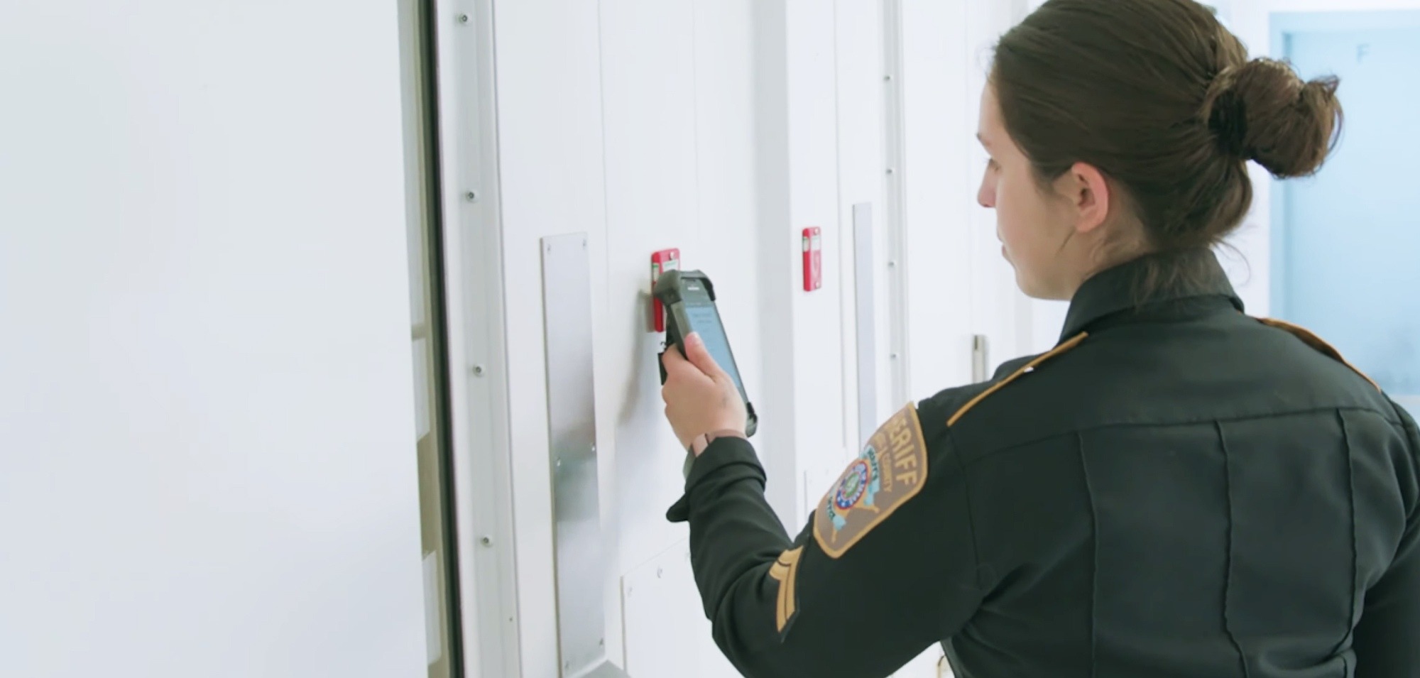 Correctional officer scanning rfid tag