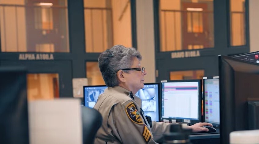 female corrections officer at control center