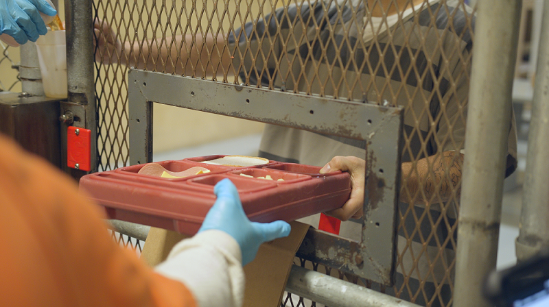 inmate receiving meal tray