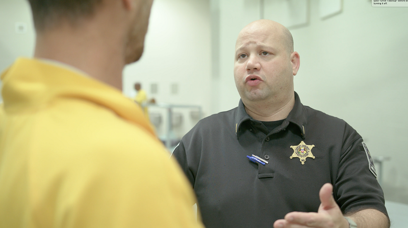 corrections officer talking to inmate